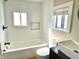 A modern bathroom features a tub, white subway tile, and black hardware at 1640 Bellefontaine St, Indianapolis, IN 46202