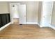 Bedroom featuring wood-look floors, neutral walls, and white doors and trim throughout at 1640 Bellefontaine St, Indianapolis, IN 46202