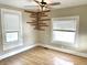 Bedroom featuring a decorative wood accent, ceiling fan, and windows with blinds at 1640 Bellefontaine St, Indianapolis, IN 46202
