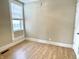 Bedroom featuring wood-look floors, neutral walls, a window and white trim throughout at 1640 Bellefontaine St, Indianapolis, IN 46202