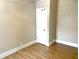 Bedroom featuring wood-look floors, neutral walls, a closet door and white trim throughout at 1640 Bellefontaine St, Indianapolis, IN 46202