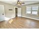 Bright bedroom features wood-look flooring, two doors, and a bright window with white trim at 1640 Bellefontaine St, Indianapolis, IN 46202