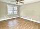 Well-lit bedroom features wood-look floors and a bright window with white trim at 1640 Bellefontaine St, Indianapolis, IN 46202