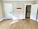 An airy bedroom features wood-look flooring, bright windows, and multiple doorways at 1640 Bellefontaine St, Indianapolis, IN 46202