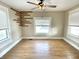 Bedroom features a ceiling fan, wood flooring, and is filled with natural light from the windows at 1640 Bellefontaine St, Indianapolis, IN 46202