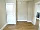Bedroom featuring wood-look floors, neutral walls, a closet door and white trim throughout at 1640 Bellefontaine St, Indianapolis, IN 46202