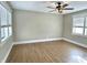 Spacious bedroom with wood-look floors, modern ceiling fan, and bright windows at 1640 Bellefontaine St, Indianapolis, IN 46202