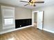 Bright bedroom featuring wood-look floors, neutral walls, a ceiling fan, and natural light from the window at 1640 Bellefontaine St, Indianapolis, IN 46202
