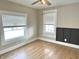 Bedroom featuring wood flooring, new windows, and a modern, paneled accent wall at 1640 Bellefontaine St, Indianapolis, IN 46202