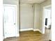 Bedroom featuring wood-look floors, neutral walls, a closet door and white trim throughout at 1640 Bellefontaine St, Indianapolis, IN 46202