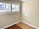 A bedroom with wood-look flooring and natural light from a large window at 1640 Bellefontaine St, Indianapolis, IN 46202