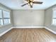 Well-lit bedroom features wood-look floors, modern ceiling fan, and large windows at 1640 Bellefontaine St, Indianapolis, IN 46202
