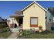 Charming yellow single Gathering home with a cozy porch and well-kept front yard, great curb appeal at 1640 Bellefontaine St, Indianapolis, IN 46202