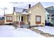 A front exterior view of a cream two-story home featuring a charming front porch with red brick at 1640 Bellefontaine St, Indianapolis, IN 46202
