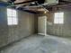 Interior shot of the garage featuring windows and a service door at 1640 Bellefontaine St, Indianapolis, IN 46202