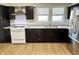 A kitchen featuring dark cabinets, granite countertops, and stainless steel appliances at 1640 Bellefontaine St, Indianapolis, IN 46202