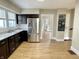 A kitchen with wood-look flooring, stainless steel appliances, and an open doorway at 1640 Bellefontaine St, Indianapolis, IN 46202