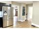 A kitchen featuring wood-look flooring, stainless steel appliances, and an open doorway at 1640 Bellefontaine St, Indianapolis, IN 46202