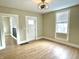 Open living room features wood-look floors, a window and a modern ceiling fan at 1640 Bellefontaine St, Indianapolis, IN 46202