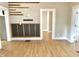 Open living room area showing wood-look floors and multiple doorways at 1640 Bellefontaine St, Indianapolis, IN 46202