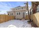 Backyard view of the home, surrounded by a wooden fence, and a tree at 19 Parkview Ave, Indianapolis, IN 46201