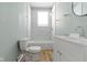 Bright bathroom features a shower-tub combo with white marble-look tile and modern white vanity at 19 Parkview Ave, Indianapolis, IN 46201