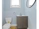 Half bathroom featuring hardwood floors and updated vanity at 19 Parkview Ave, Indianapolis, IN 46201