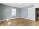 Bedroom featuring one window allowing natural light and beautiful new wood flooring at 19 Parkview Ave, Indianapolis, IN 46201