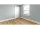 Bedroom featuring one window allowing natural light and beautiful new wood flooring at 19 Parkview Ave, Indianapolis, IN 46201