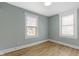 Bedroom with two large windows allowing natural light and beautiful new wood flooring at 19 Parkview Ave, Indianapolis, IN 46201