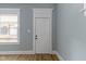Bright room with fresh paint, new hardwood flooring, and a classic white door at 19 Parkview Ave, Indianapolis, IN 46201