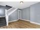 Bright room with fresh paint, new hardwood flooring, and a staircase at 19 Parkview Ave, Indianapolis, IN 46201