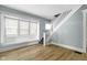 Bright living room featuring hardwood floors, large windows, and staircase with white banister at 19 Parkview Ave, Indianapolis, IN 46201