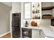 Entertainer's bar area boasts a wine fridge, beverage center, custom cabinets and ample counter space at 2071 Eagle Trace Dr, Greenwood, IN 46143