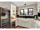 Entertainer's bar area boasts a wine fridge, beverage center, custom cabinets and ample counter space at 2071 Eagle Trace Dr, Greenwood, IN 46143