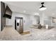 Bar area with a stainless steel refrigerator, granite countertops, ample storage, and modern fixtures at 2071 Eagle Trace Dr, Greenwood, IN 46143