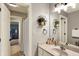 Neutral bathroom showcasing a modern mirror, decorative plants, and a single sink vanity at 2071 Eagle Trace Dr, Greenwood, IN 46143