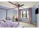 A bedroom with a canopy bed, desk, window, and purple lighting at 2071 Eagle Trace Dr, Greenwood, IN 46143