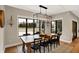 Elegant dining room boasts modern lighting, a rustic wood table, and large windows overlooking the backyard at 2071 Eagle Trace Dr, Greenwood, IN 46143