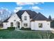 Beautiful white brick home featuring dark accents, manicured landscaping, and an inviting entrance at 2071 Eagle Trace Dr, Greenwood, IN 46143