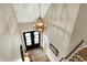 Grand two-story foyer featuring a spherical chandelier, black double doors and hardwood floors at 2071 Eagle Trace Dr, Greenwood, IN 46143
