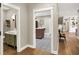 Hallway view of the powder room with a green vanity and utility room with decorative tile flooring at 2071 Eagle Trace Dr, Greenwood, IN 46143