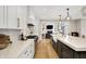 Modern kitchen with white marble countertops, island with sink, stainless steel appliances, and ample storage at 2071 Eagle Trace Dr, Greenwood, IN 46143