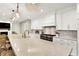Bright kitchen features a marble island, stainless steel appliances, and custom white cabinets at 2071 Eagle Trace Dr, Greenwood, IN 46143