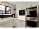 Modern kitchen features stainless steel appliances, white cabinets and a built in coffee maker at 2071 Eagle Trace Dr, Greenwood, IN 46143