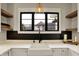 Modern kitchen features a black faucet, white farmhouse sink, black backsplash and floating shelves at 2071 Eagle Trace Dr, Greenwood, IN 46143