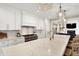 Bright kitchen boasts white cabinets, marble countertops, stainless steel appliances, and island seating at 2071 Eagle Trace Dr, Greenwood, IN 46143
