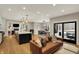Open-concept living room featuring a fireplace, wood floors, and sliding glass doors to an outdoor living area at 2071 Eagle Trace Dr, Greenwood, IN 46143