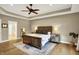Large main bedroom featuring tray ceilings, a ceiling fan, a bed, and an ensuite bath at 2071 Eagle Trace Dr, Greenwood, IN 46143