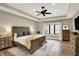 Spacious bedroom with tray ceilings, a ceiling fan, a plush rug, and a king-size bed at 2071 Eagle Trace Dr, Greenwood, IN 46143